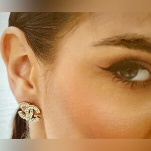 Gorgeous and eye-catching gold tone metal stud earrings with crystals. New.